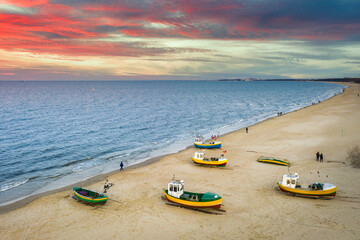 Fototapeta premium Amazing sunset with fishing boats at the beach of Baltic Sea in Sopot, Poland