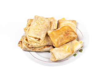 Studio lighting. homemade cakes. in a plate of rolled-up pancakes with stuffing in an envelope. With liver. On a white background. Close-up