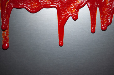 Ketchup, tomato sauce on a dark glossy background