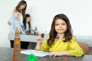 Obraz premium Child using 3D printing pen. Girl making new item. Creative, technology, leisure, education concept