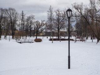 city park in the snow in winter