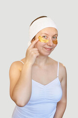 Eye patch procedure. Facial hydrogel treatment. Dermatology spa mask. Detox therapy. Rejuvenation skincare beauty. Cosmetics gold product. Light background. Self care home routine. Happy face