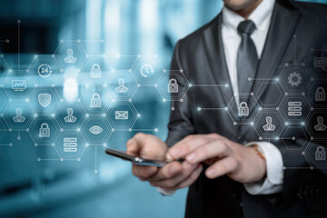 Businessman working in security system on virtual screen and phone.