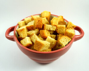 bowl with small croutons on a white plate close up