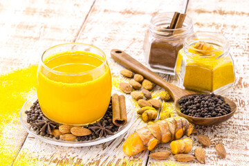Golden milk, made with turmeric and other spices, healthy saffron drink, cinnamon, star anise, black pepper and almonds