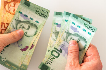 Costa Rican money held in my hands, A large amount of banknotes