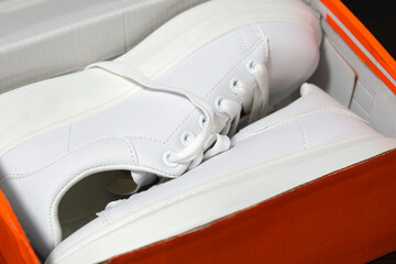 White new sneakers in a box. Purchase of sports shoes. Stylish sports shoes concept