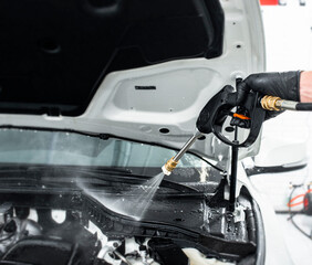 Fototapeta premium Car detailing maintenance, cleaning engine with the high pressure cleaner