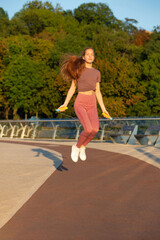 ginger woman doing workout with a skipping rope