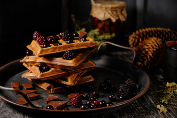 Homemade waffles with chocolate berries and pine cone jam