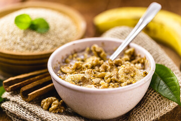 walnuts, cinnamon and banana porridge in a recycled plastic bowl