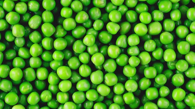 Moving Green Peas Background And Texture. View From Above.