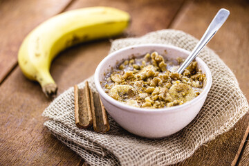 walnuts, cinnamon and banana porridge in a recycled plastic bowl