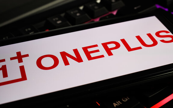 Viersen, Germany - March 1. 2021: Closeup of smartphone screen with logo lettering of chinese oneplus mobile phone company on computer keyboard