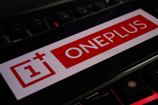 Viersen, Germany - March 1. 2021: Closeup of smartphone screen with logo lettering of chinese oneplus mobile phone company on computer keyboard