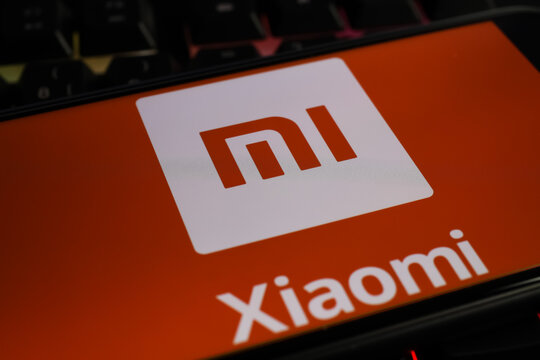 Viersen, Germany - March 1. 2021: Closeup of smartphone screen with logo lettering of chinese xiaomi mobile phone company on computer keyboard