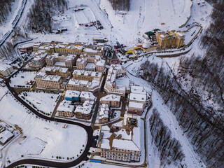 Winter aerial view of the road to ski resort Krasnaya Polyana with apartment buildings, hotels,...
