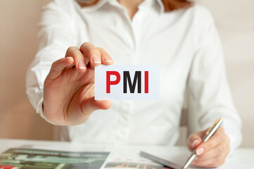 a woman in a white shirt holds a piece of paper with the text PMI, business concept