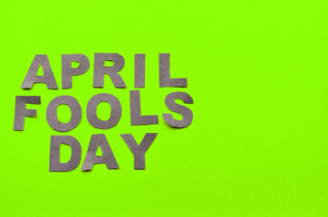 Image caption April Fools' Day made of grey letters on a green background with a copy space. High quality photo