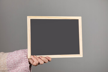 woman holding blackboard