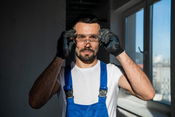 The man in gloves and goggles smiles kindly