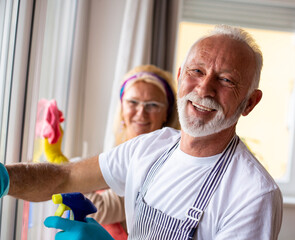 Senior couple cleaning windows