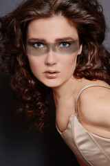 Fototapeta premium Close-up portrait of beautiful woman with fancy golden makeup