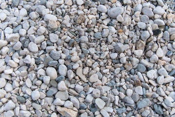 Pebbles beach on sea surface with grey stones: Abstract Composition for background and texture.