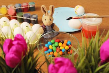 easter bunny with easter eggs and tulips. painting Easter eggs. Happy family is preparing for Easter. Happy easter! Easter bunny.