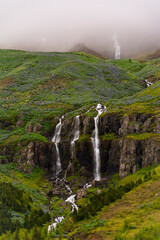 spectacular waterfall on a eastern Icelandic fjord near Seydisfjordur during summer season