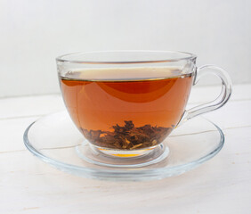 Tea. green Tea. Herbal tea. Mint leaf. Tea with apple flavor. Tea in a glass cup with apple blossoms and leaves dried tea sliced lime. herbs tea and mint leaves on a slate plate in a restaurant or tea