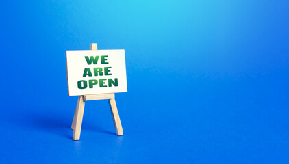 We Are Open easel sign. Exit from severe quarantine conditions, economic and business recovery. Return to normal life. Adaptation to rules. Business flexibility and readiness for new challenges.