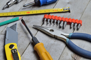 some home repair tools lie on a wooden background. close-up.