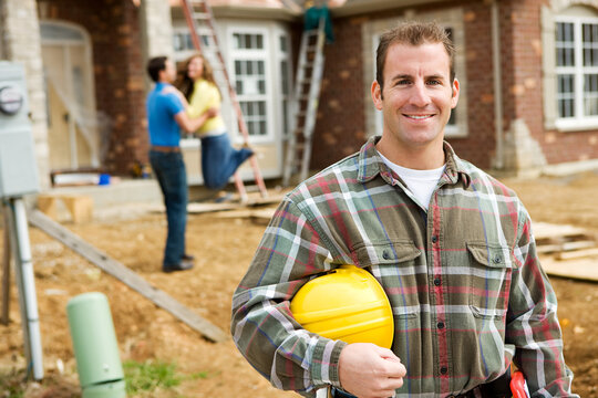 Construction: Contractor with Excited Home Owners in Background