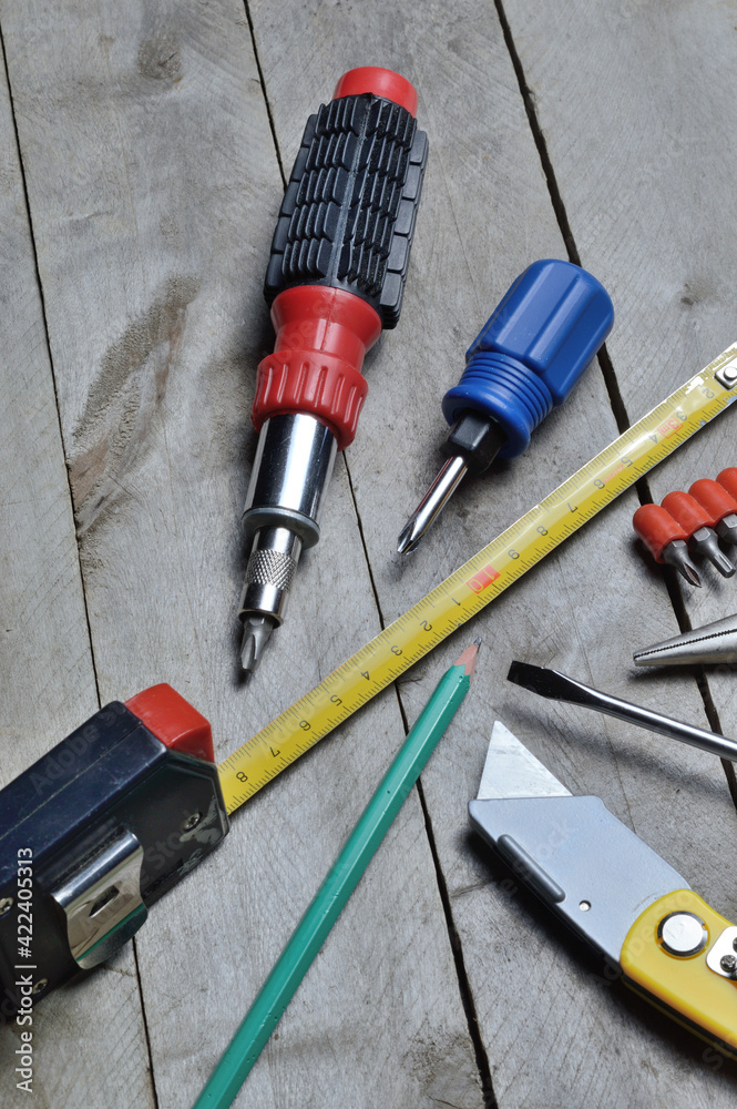 Wall mural some home repair tools lie on a wooden background. close-up.