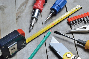 some home repair tools lie on a wooden background. close-up.