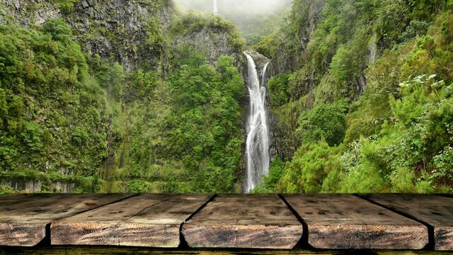 Empty wooden table background with waterfall in the forest