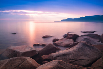  stones conveys a romantic feeling on a desert coastline with water