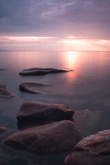landscape with stones conveys a romantic feeling on a desert coastline with water