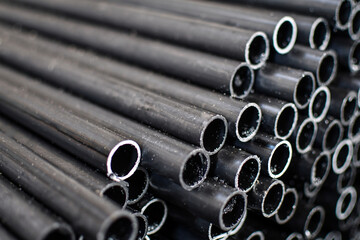 Stack of steel pipes for industrial background. Selective focus