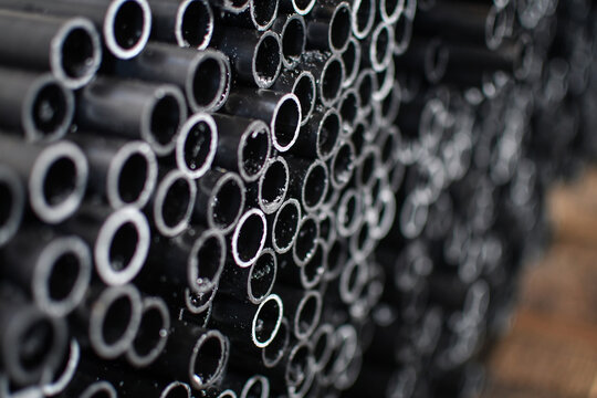 Stack of steel pipes with blurred background. Selective focus