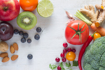 Vegetables and fruits on white wooden background, healthy diet concept