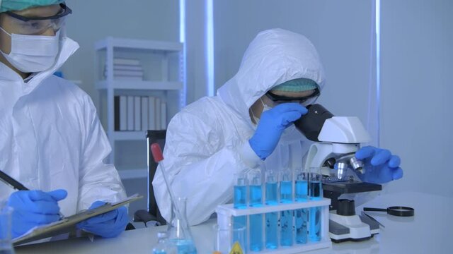 Research concept of 4k resolution. Scientists wear protective clothing to work in the laboratory.