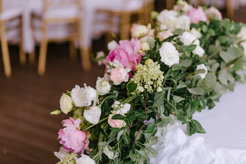 Close-up of a composition of white and pink flowers for a wedding table decoration of the newlyweds