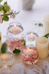Close up of wedding decoration using different flowers and candles. Natural decorating for wedding tables for guests 