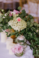 Close up of wedding decoration using different flowers and candles. Natural decorating for wedding tables for guests 