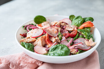 Salad with spinach, grilled salmon, radish and Sicilian red oranges. Concept for a tasty and healthy food. Top view.