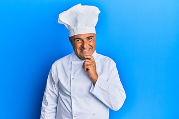Mature middle east man wearing professional cook uniform and hat looking confident at the camera...