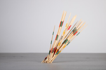 mikado game sticks, fallen down on a wooden board, motion blur