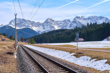 The railway road on the background of Alps mountains in the snow in Klais, Krün, Bayern